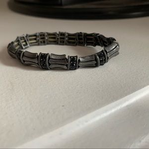 Silver bracelet with small black beads